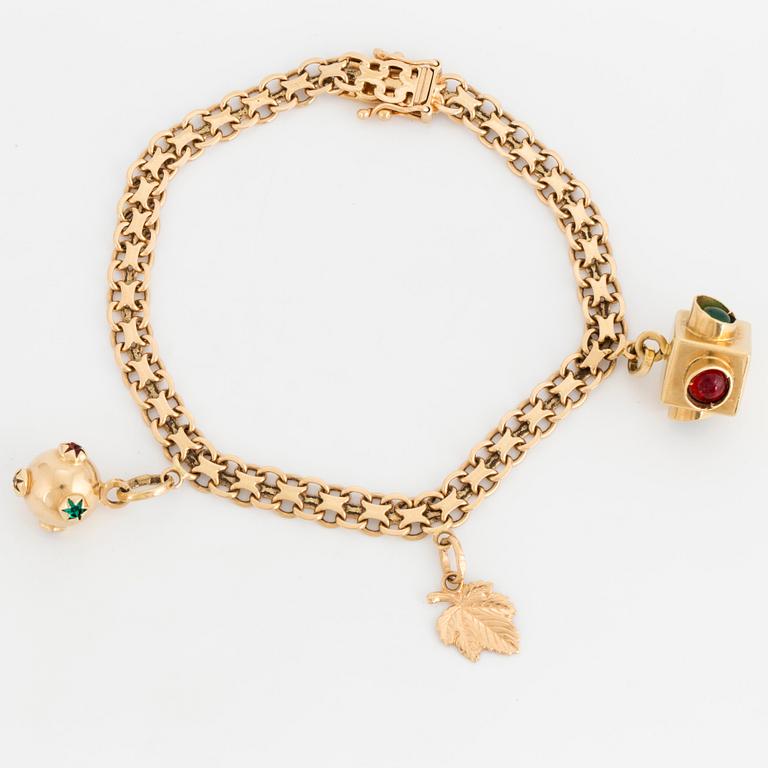 A charm bracelet, 18K gold.