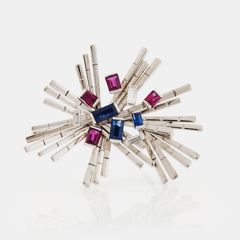 A WA Bolin brooch in 18K white gold set with baguette-cut diamonds, sapphires and rubies.