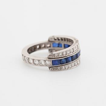 A square cut sapphire and single cut diamond ring.