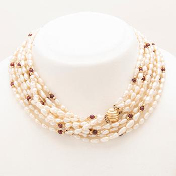Multi-strand necklace with clasp and beads in 14K gold, cultured pearls, and garnet beads.