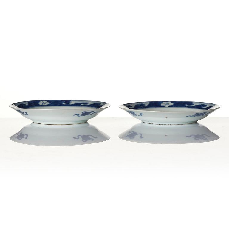 A pair of blue and white 'dragon and fish dishes', Qing dynasty, Kangxi (1662-1722).