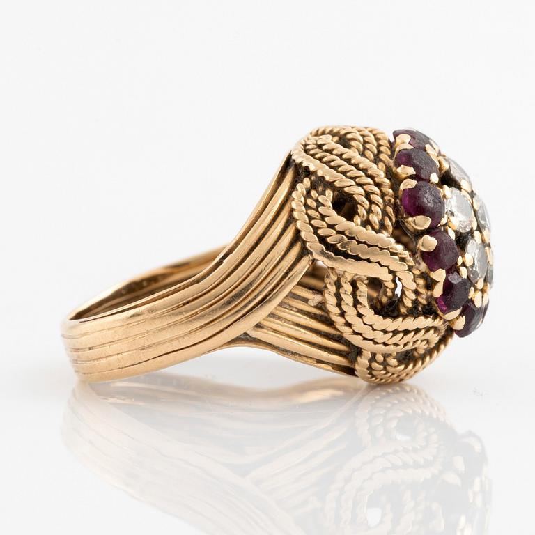 An 18K gold ring set with round brilliant-cut diamonds and rubies.