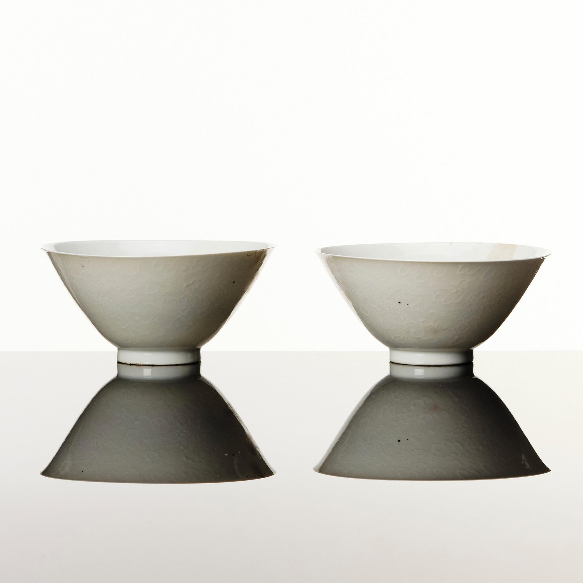 Two Chinese white glazed anhua decorated dragon bowls, Qing dynasty.