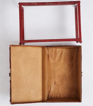 A red lacquered chest on a later stand, late Qing dynasty, 19th Century.