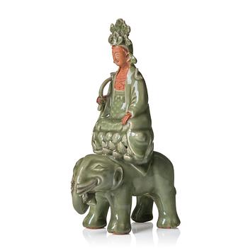 964. A celadon and bisquit figure of Guanyin seated on an elephant, presumably Longquan, Ming dynasty, 17th Century.