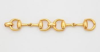 An 18K gold Gucci bracelet.