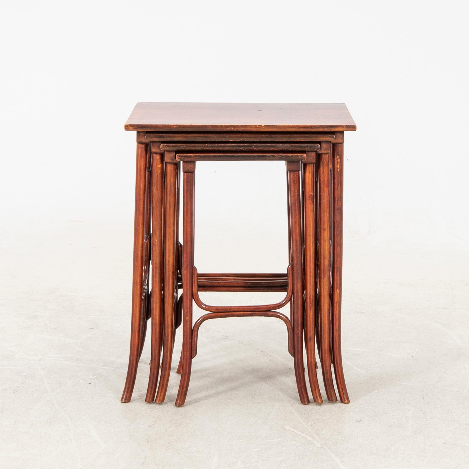 An early 19th century nest of four tables in stained beech from Thonet.