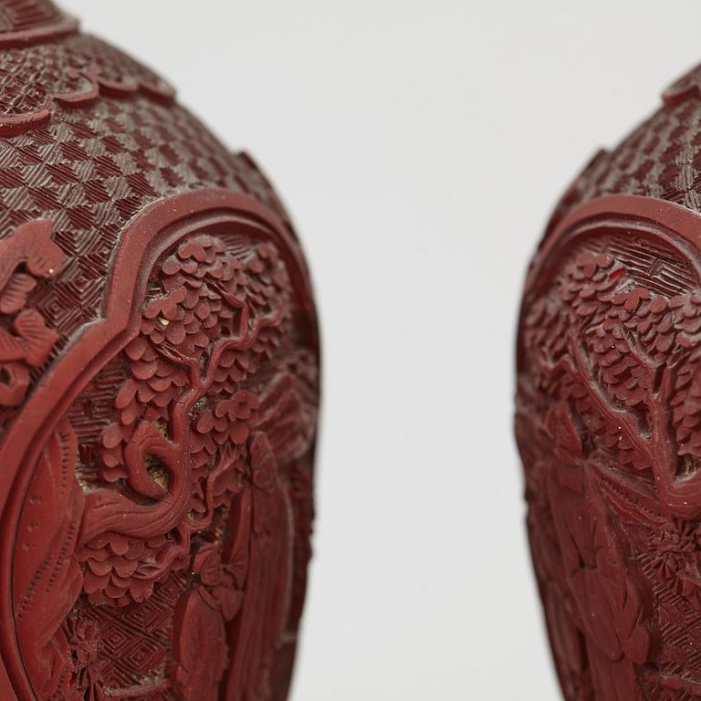 A pair of Chinese red lacquered vases, turned into table lamps, 20th century.