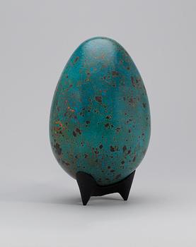 A Hans Hedberg faience egg on an iron stand, Biot, France.