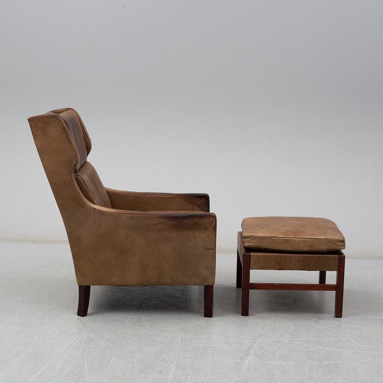 A 1960s easy chair and foot stool.