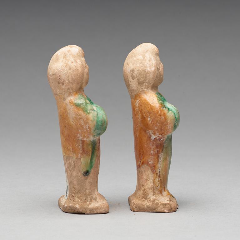 Two green and yellow glazed pottery figures of female attendants, Ming dynasty (1368-1644).