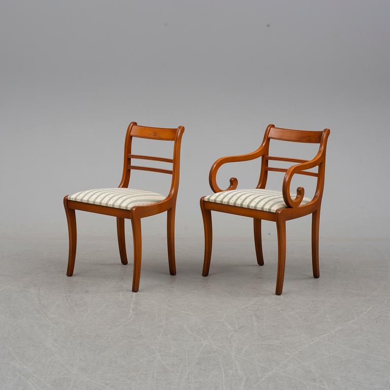 a late 20th century dining table with eight chairs.