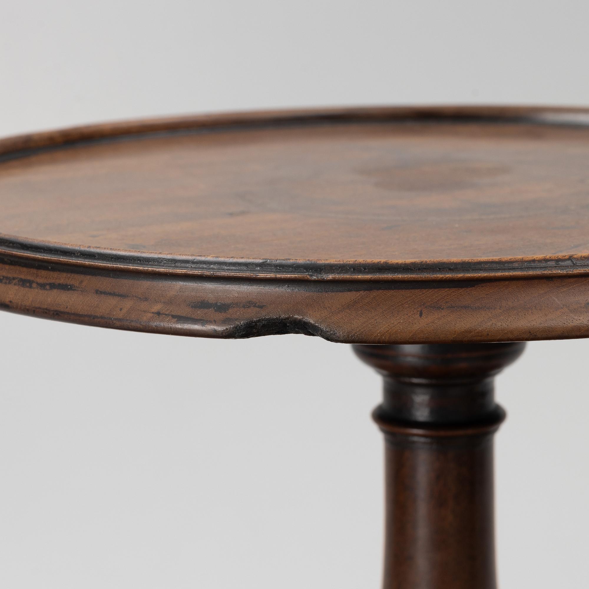 A mahogany three-tier table, England, circa 1900.