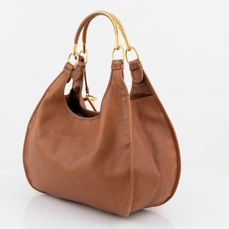 Christian Dior, a brown leather handbag.