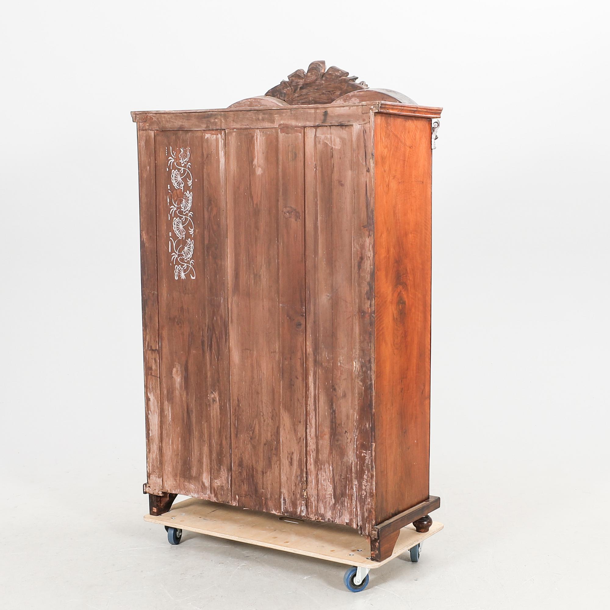A walnut display cabinet around 1900.