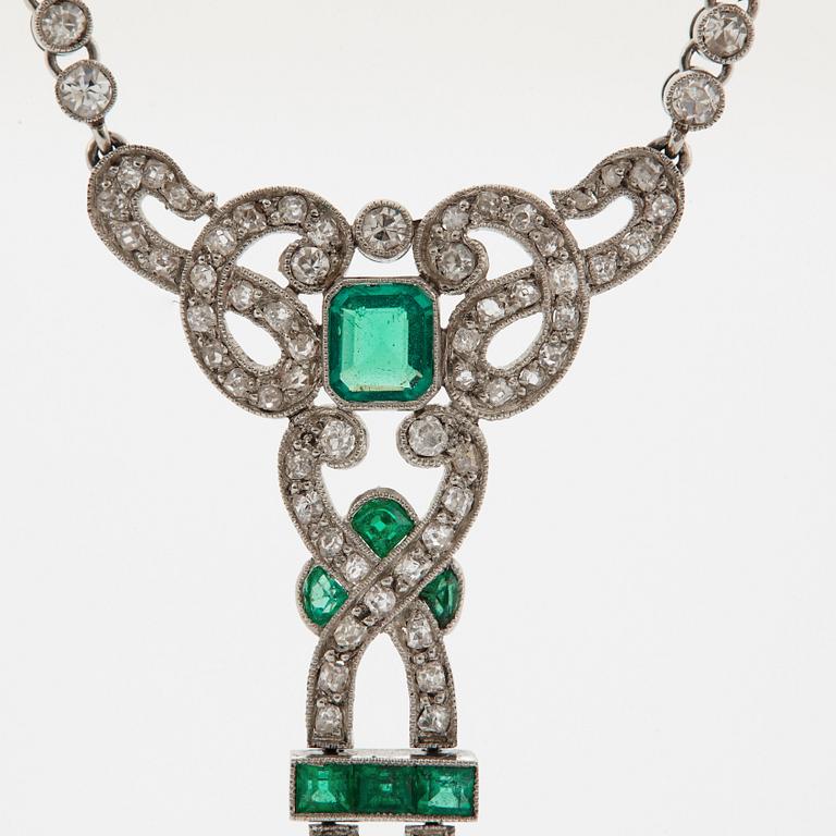 A platinum necklace set with faceted emeralds and old- and eight-cut diamonds.