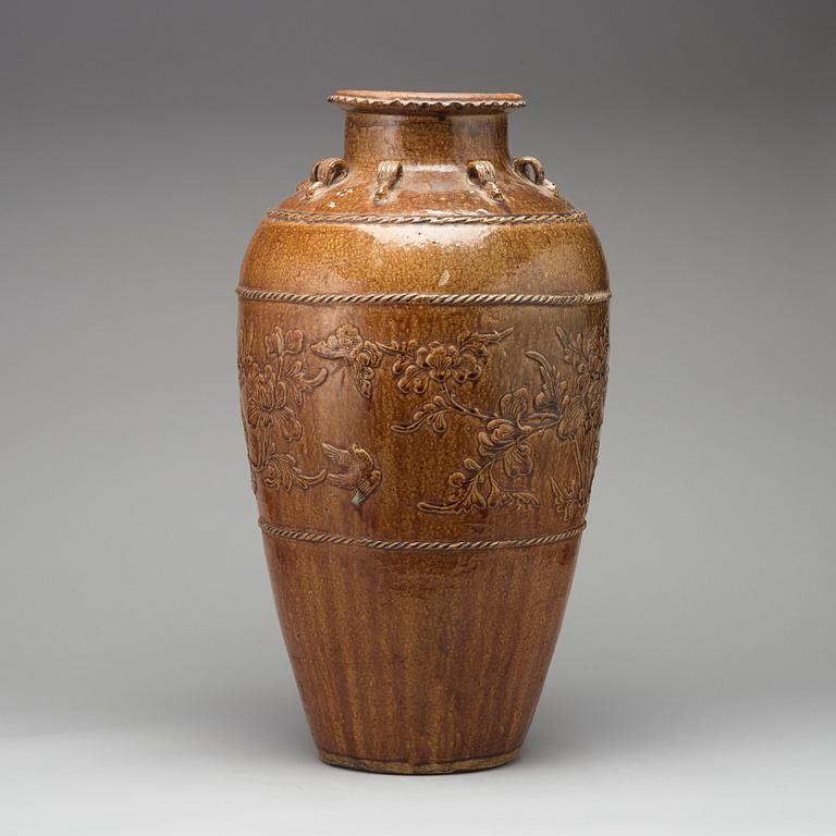 A large brown glazed Martaban jar, presumably 18th Century.