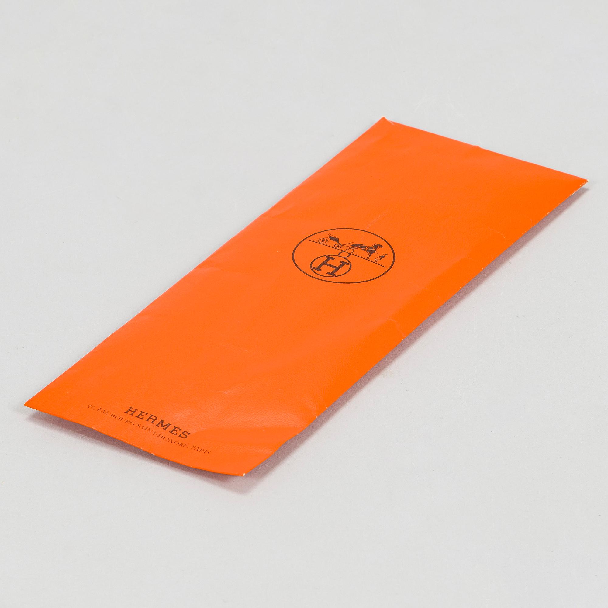 Hermès, a 'Les Rubans du Cheval' silk scarf.