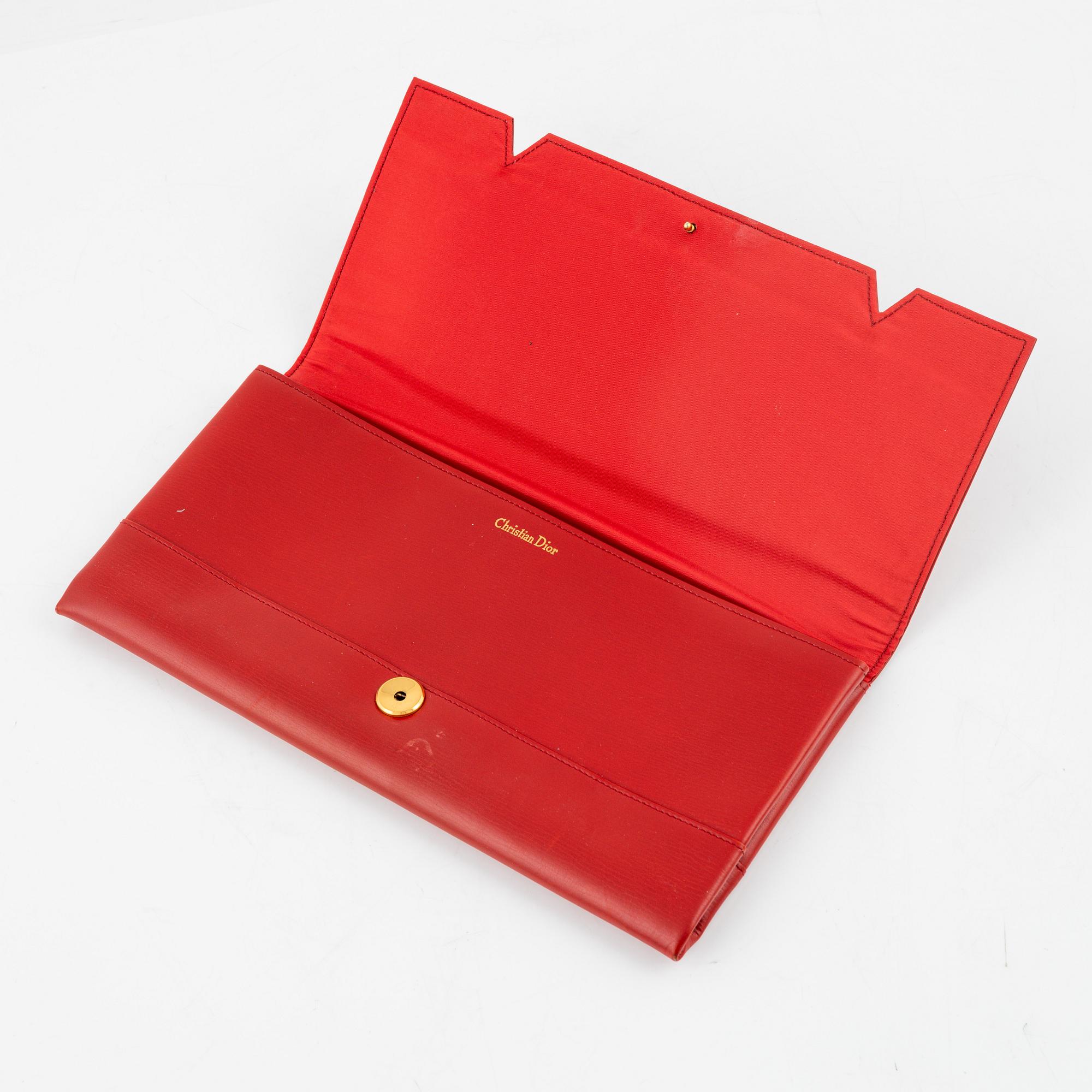 Christian Dior, a red box calf leather clutch.