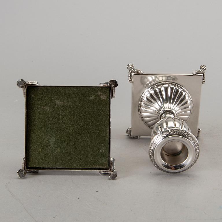 A silver bowl on foot, a pair of candlesticks and a spoon. early 20th century. Total weight app. 800 gram.