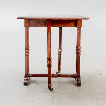 A 20th century English mahogany folding table.