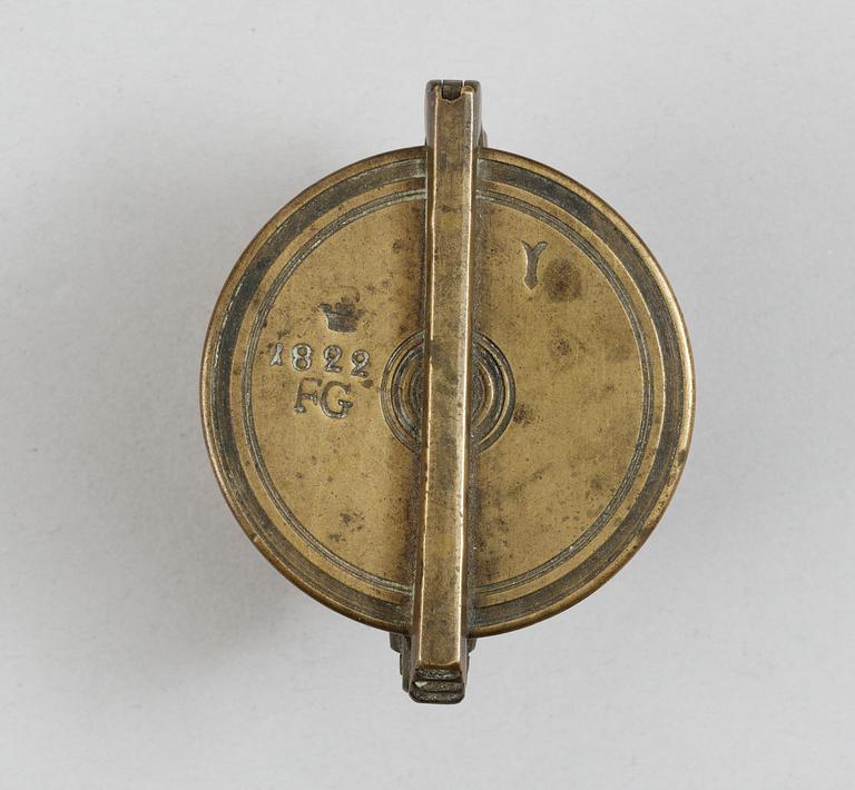 A brass set of measure, marked 1822.