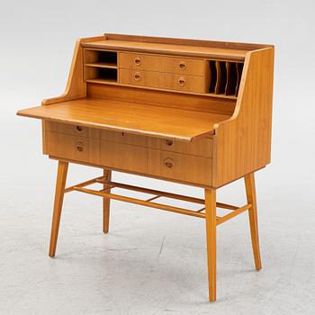 A teak-veneered desk, mid 20th century.