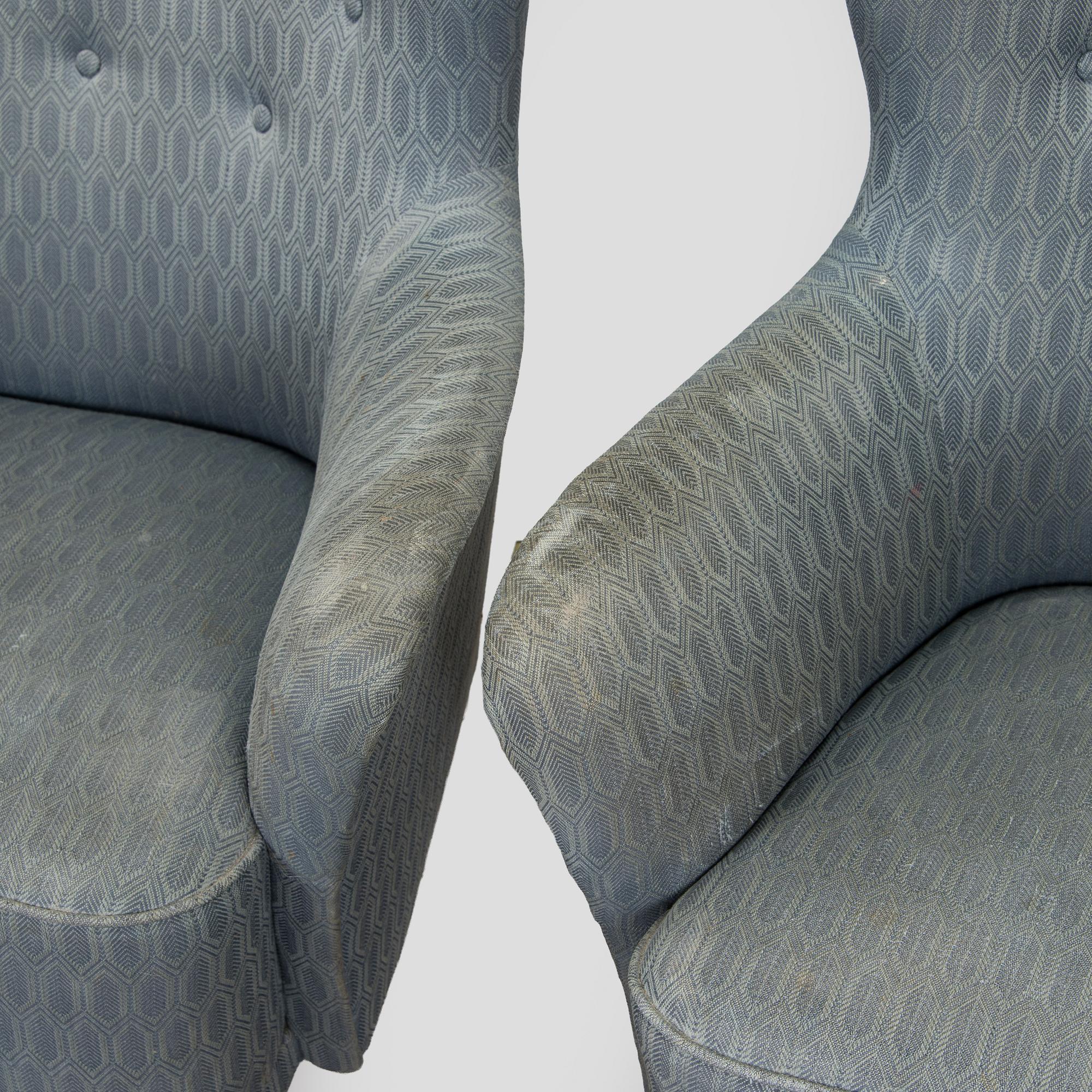 A pair of mid-20th century armchairs.