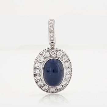 A PENDANT set with an oval cabochon-cut sapphire and round brilliant-cut diamonds.