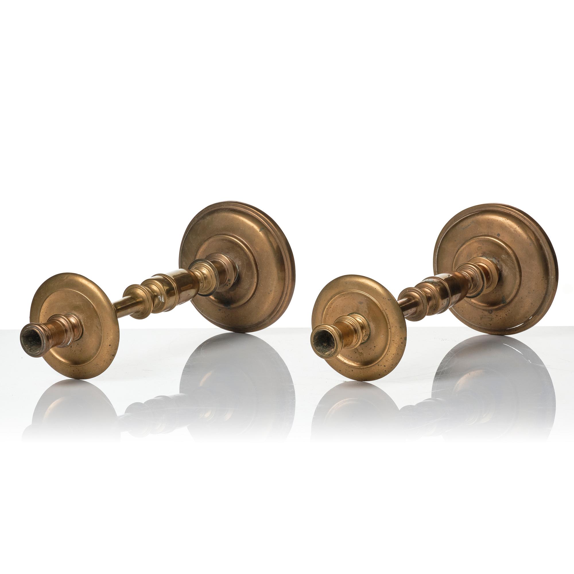 A pair of baroque brass candlesticks, 18th century.