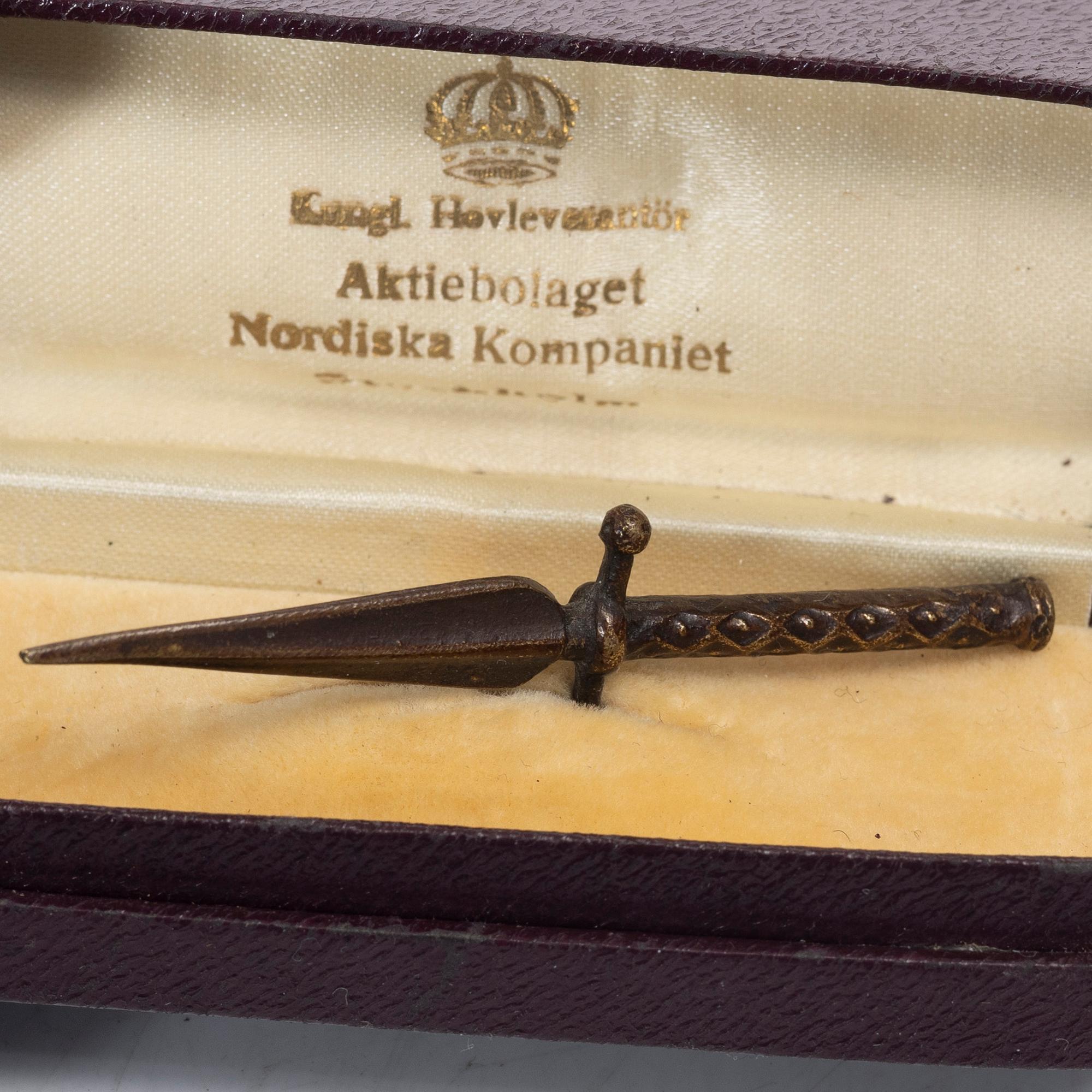 An aluminium bucket, a wooden case, four rings and two miniature knives, Finland and Russia, early 1900s.