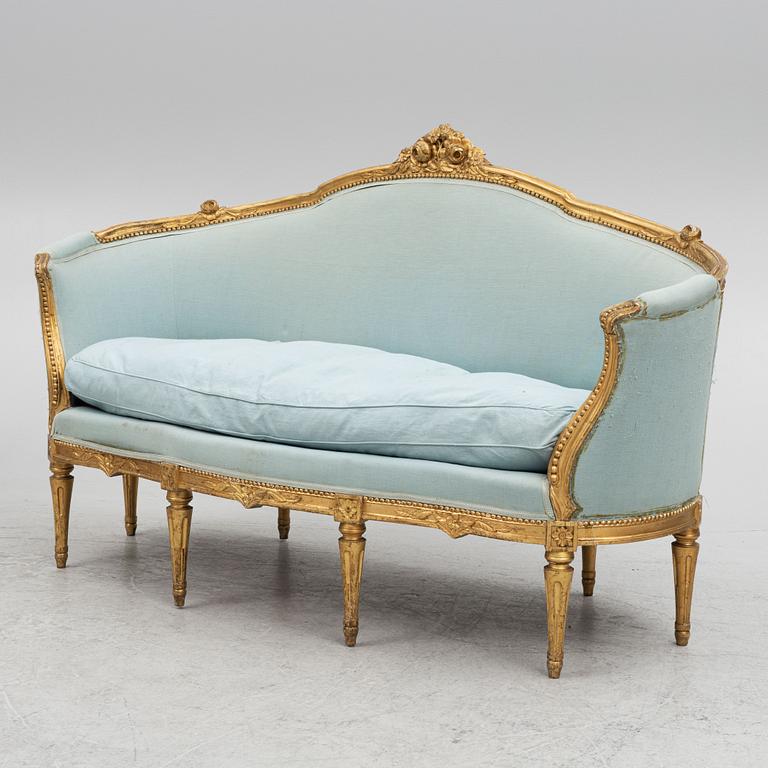 A sofa and a pair of chairs, Louis XVI style, circa 1900.