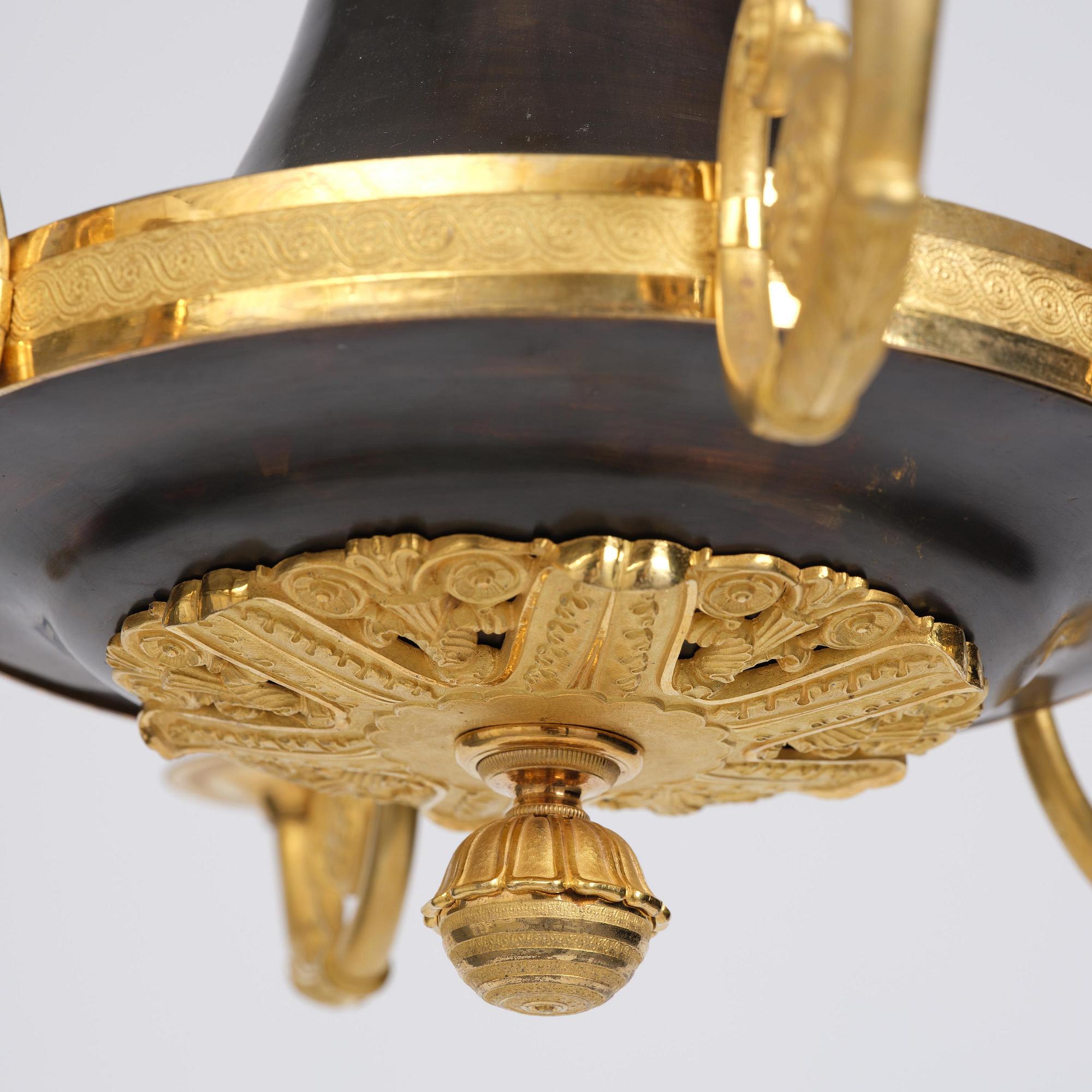 A Swedish Empire ormolu and patinated six-branch chandelier, Stockholm, early 19th century.