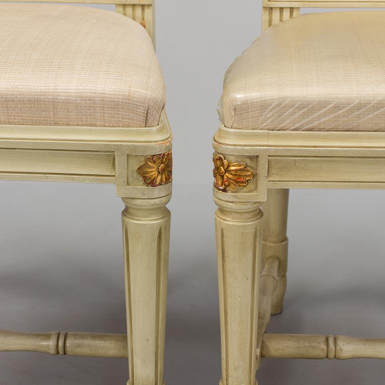 A lot of four mid 20th century Swedish Gustavian style chairs and one dinner table from around year 1900.