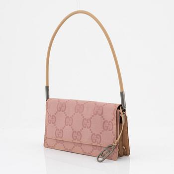 Gucci, a pink canvas handbag.