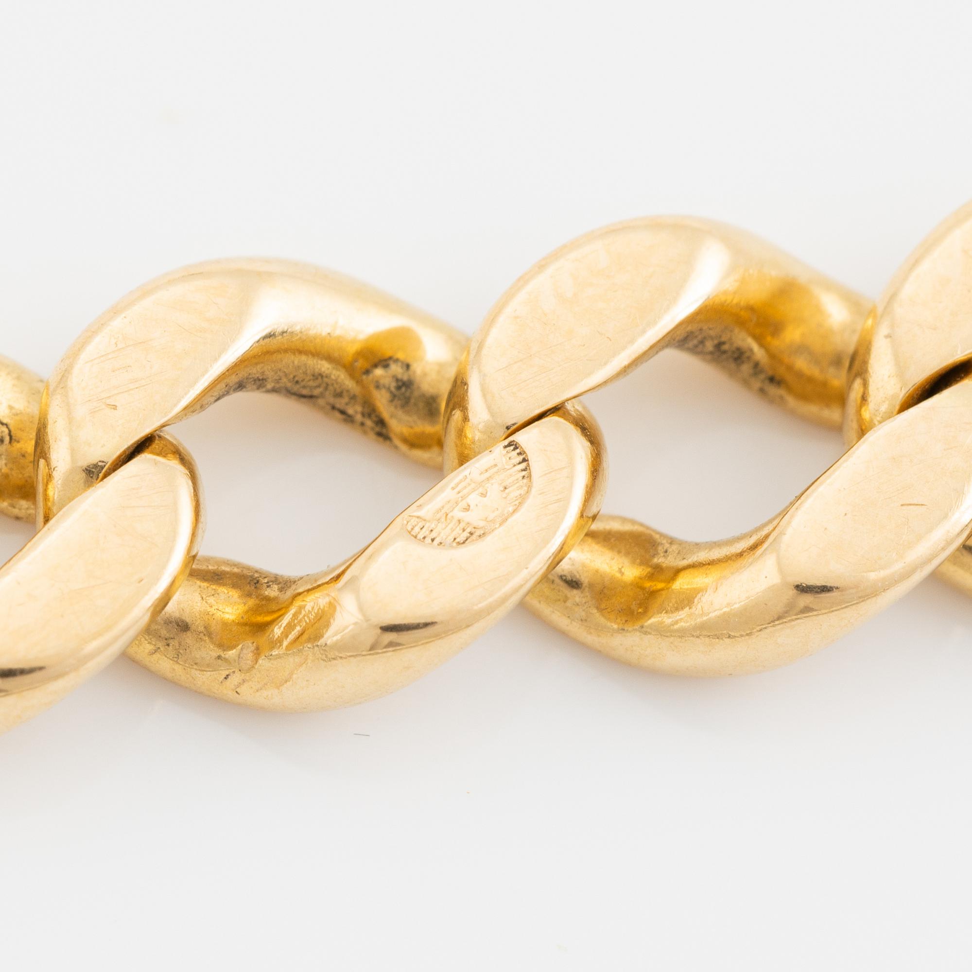18K gold curb link bracelet.