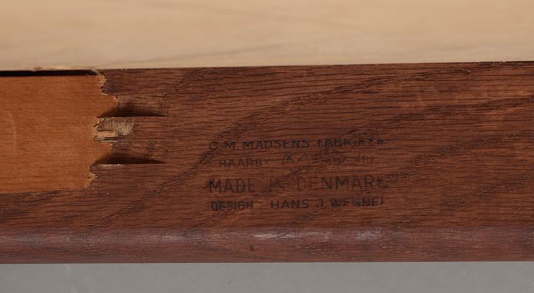 A Hans J Wegner oak dinner table 'AT 312' and four oak and black leather chairs, C M Madsen, Denmark 1950-60's.