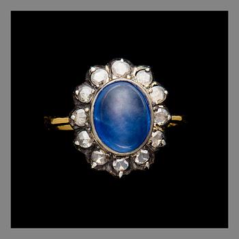 A RING, 14K (56) gold, cabochon cut sapphire, rose cut diamonds. Weight c. 4.4 g.