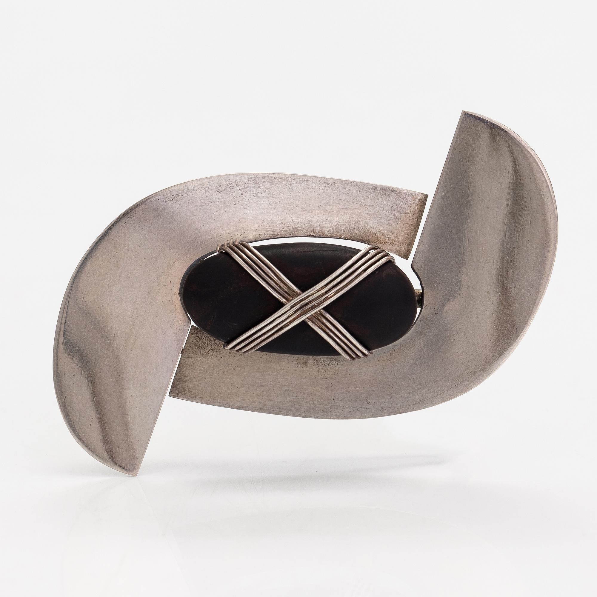 Paula Häiväoja, a sterling silver brooch with a natural stone "kiveen sidottu musta". Pentti Roos/Studio Paula, Helsinki.
