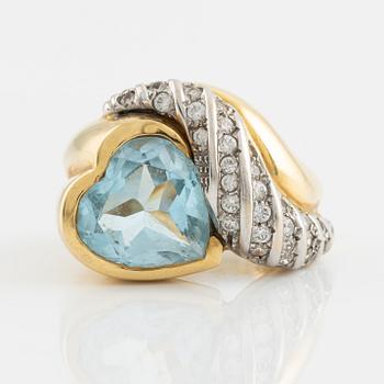 18K gold and heart shaped blue topaz and white stones.