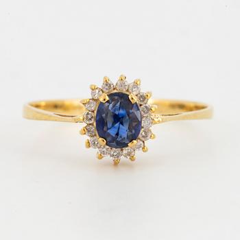 Oval mixed-cut sapphire and round brilliant-cut diamond halo ring.