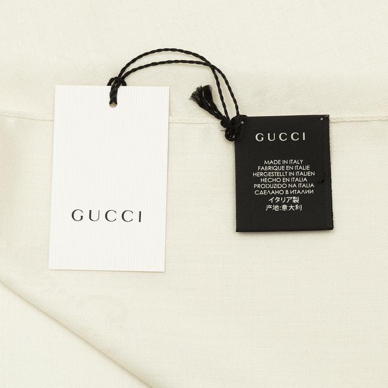 Gucci, a wool and silk mix "GG" jaquard shawl.