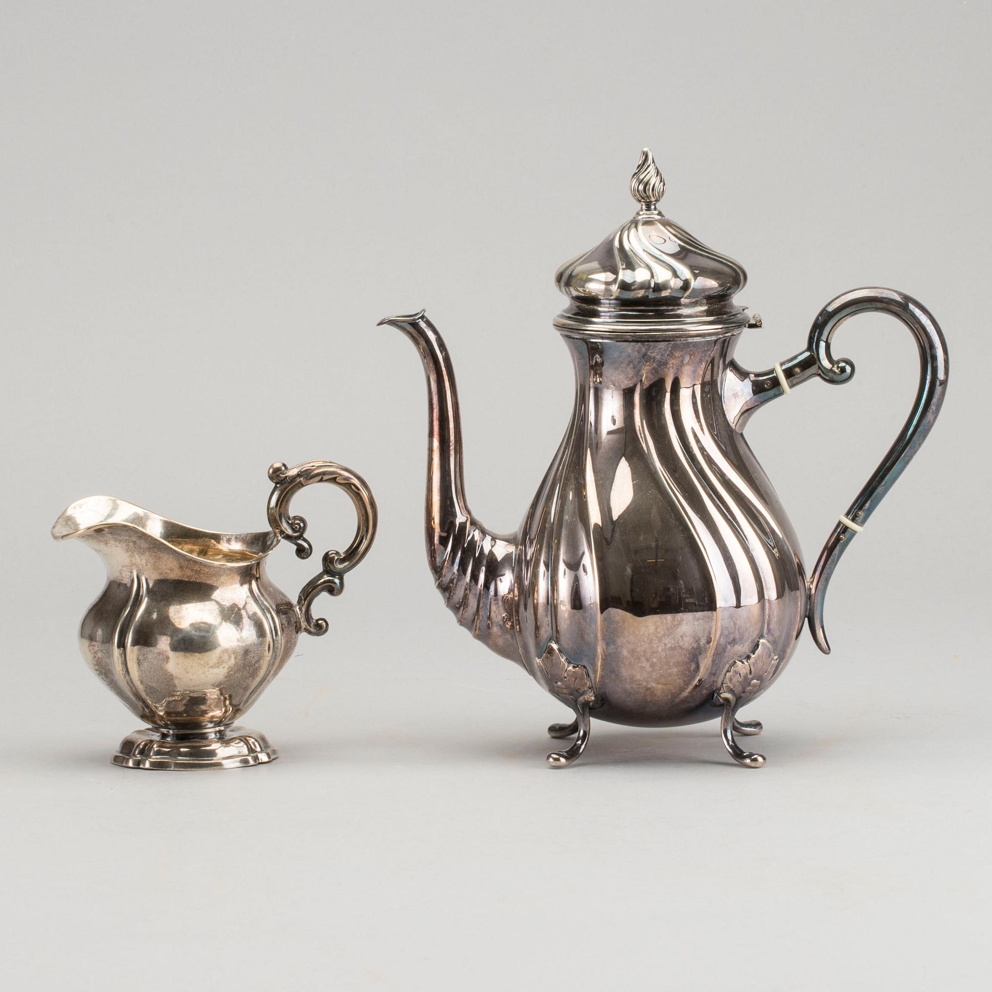 A DANISH COFFEE POT AND A SWEDISH CREAMER, silver.