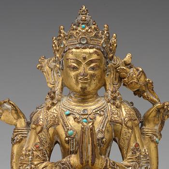 A gilt copper alloy four armed Sadaksari Avalokiteshvara, Tibet/Nepal, 15th Century or older.