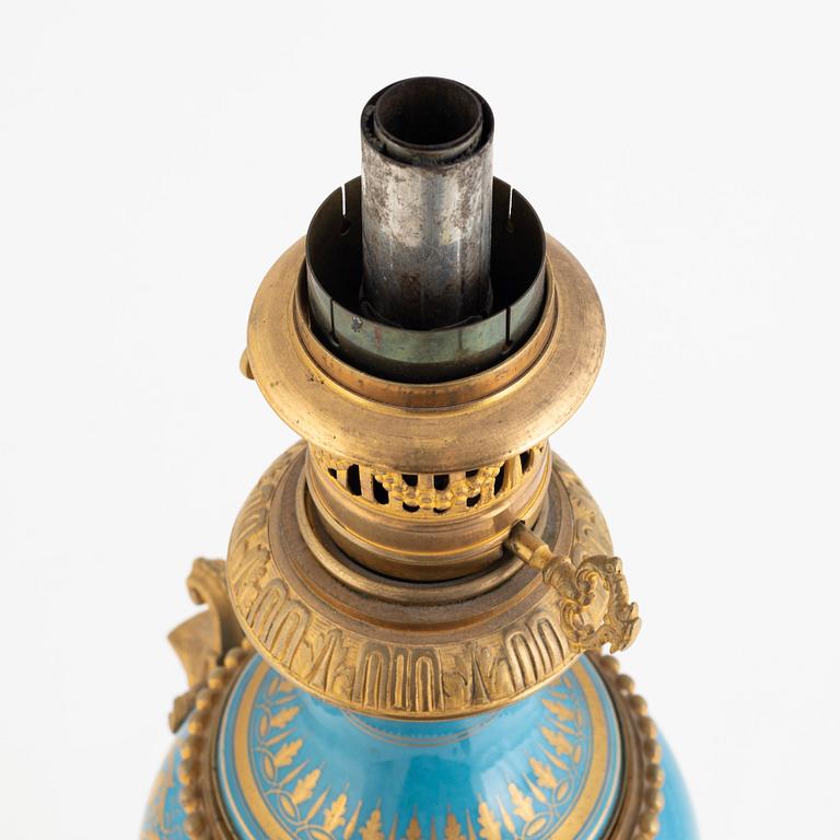 A gilt-brass and porcelaine Louis XVI-style kerosene lamp, later part 19th century.