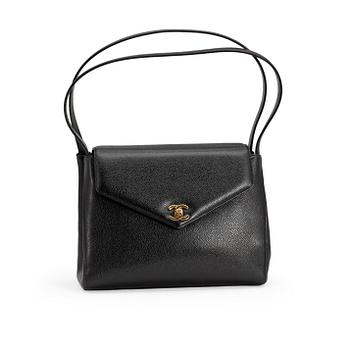 CHANEL, a black caviar leather shoulder bag with gold colored CC lock.