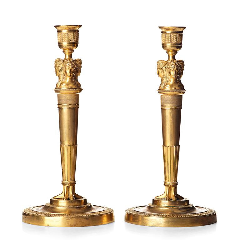 A pair of French Empire early 19th century gilt bronze candlesticks.