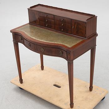 An English mahogany-veneered desk, late 20th century.