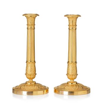 151. A pair of French Empire ormolu candlesticks, Paris, early 19th century.