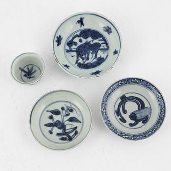 A blue and white cup and three dishes, Ming dynasty (1368-1644).